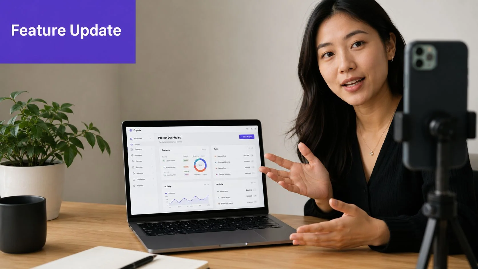 A woman presenting a project dashboard on her laptop while recording a video update for her audience.